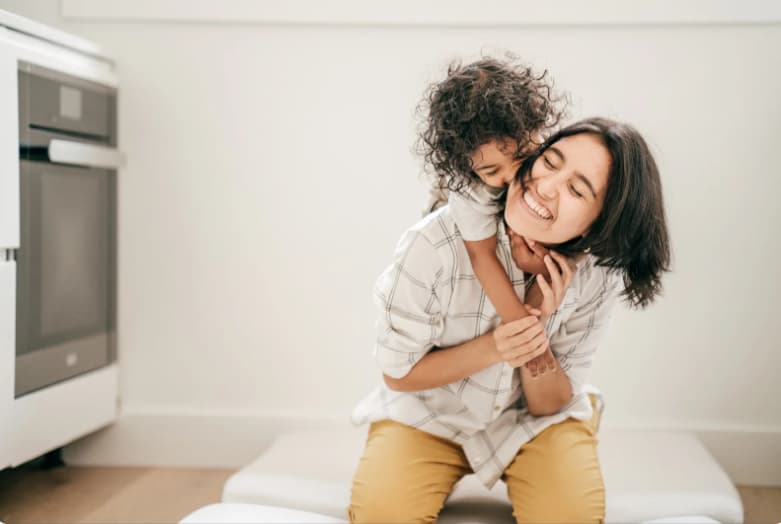 Mom and child sharing a joyful hug — therapy that strengthens connection